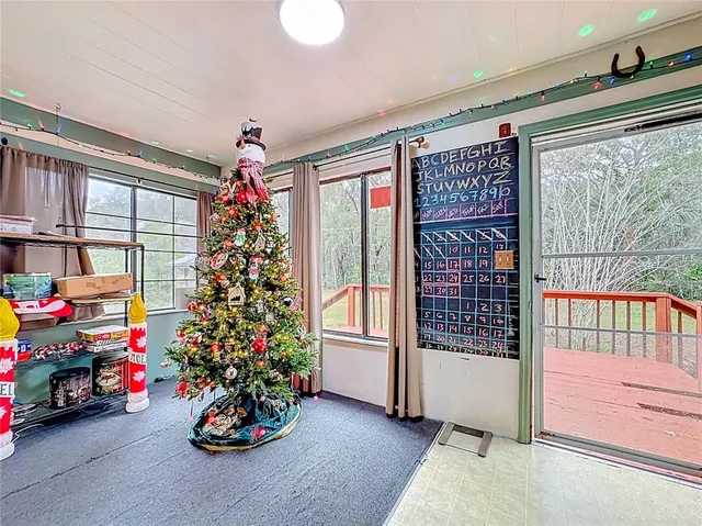 a christmas tree sitting in front of a window with flowers
