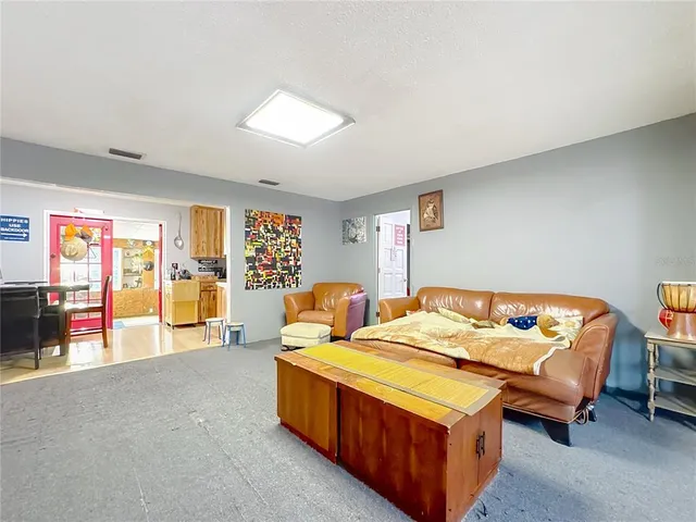 a bedroom with furniture and large windows