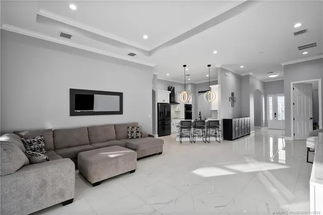 a living room with furniture and kitchen view