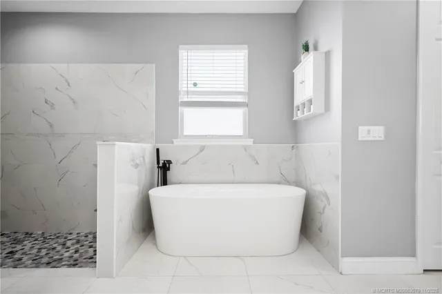 a large kitchen with a table and a clock