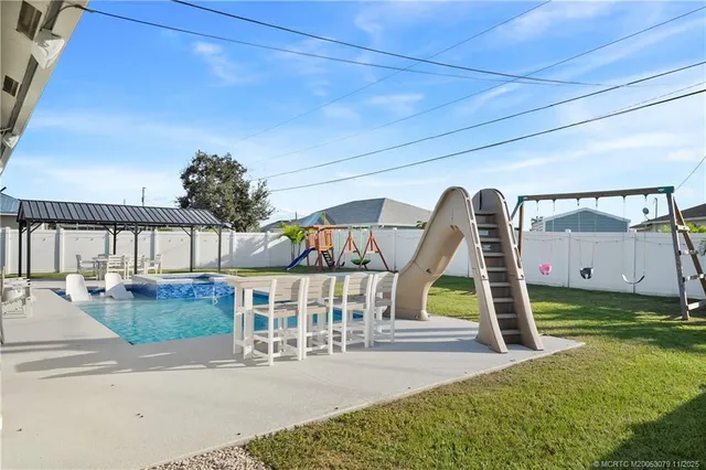 a view of swimming pool with seating space