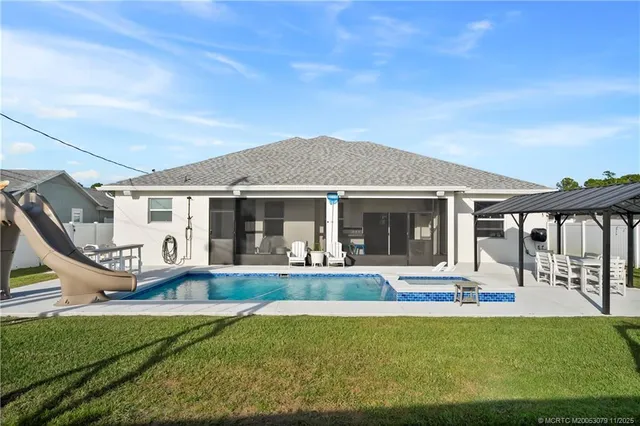 a front view of house with outdoor seating and yard