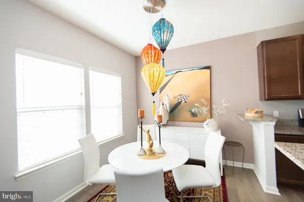 a dining room with furniture a wooden floor and a chandelier
