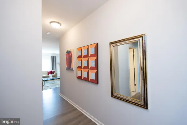 an entryway and a hallway with wooden floor