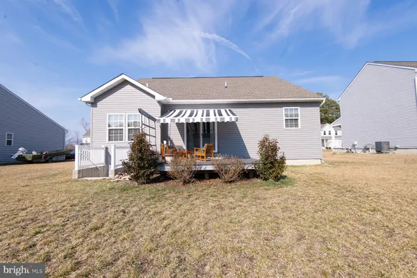 a view of a house with backyard porch and sitting area