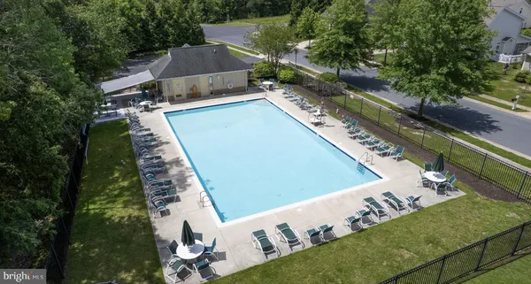 a view of a swimming pool with a yard