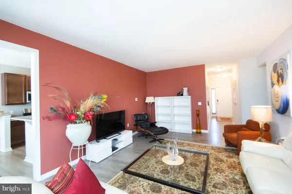 a living room with furniture and a chandelier