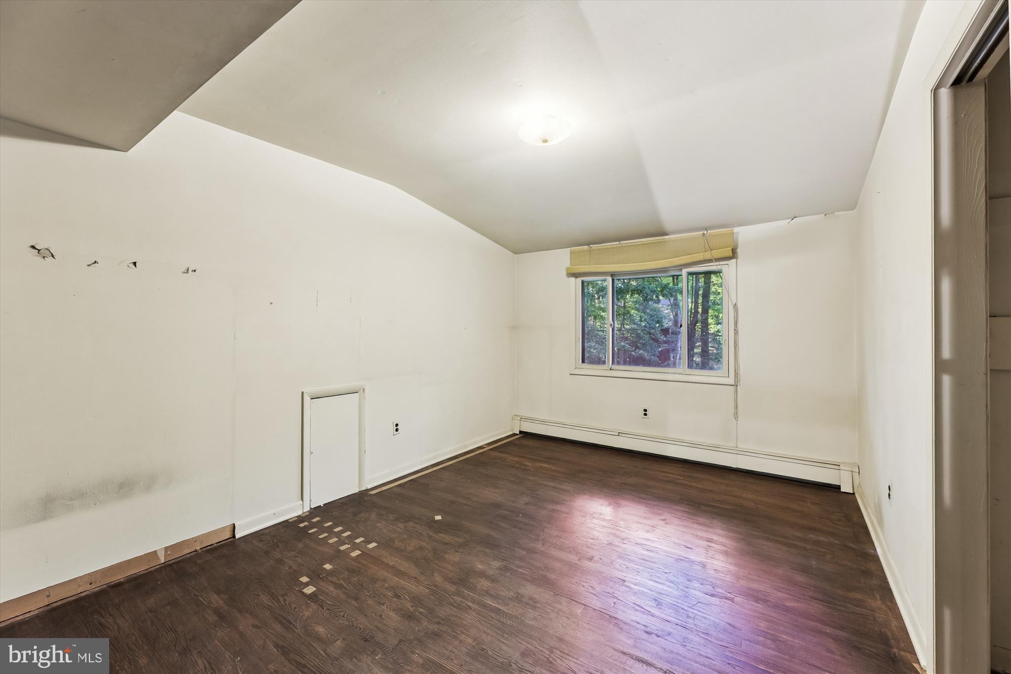 15120 Reserve Road Accokeek, MD 20607 - Photo 23 of 32 an empty room with wooden floor and windows