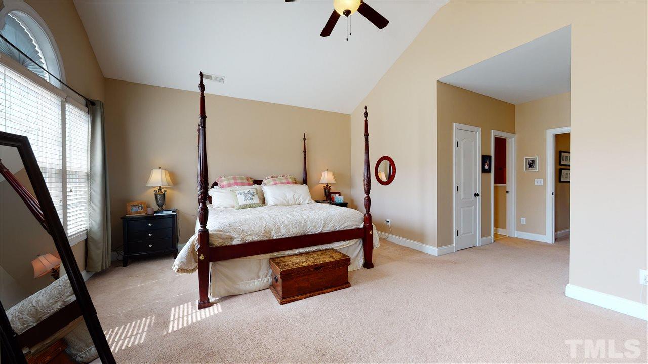 628 Democracy Street Raleigh, NC 27603 - Photo 17 of 26 a bedroom with a bed closet and a window