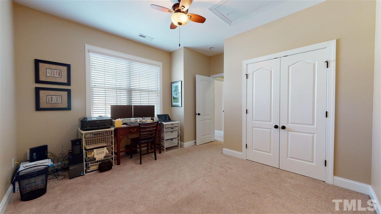 628 Democracy Street Raleigh, NC 27603 - Photo 20 of 26 a view of a workspace with furniture and a window