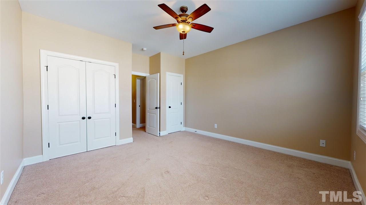 628 Democracy Street Raleigh, NC 27603 - Photo 21 of 26 an empty room with closet and a chandelier fan