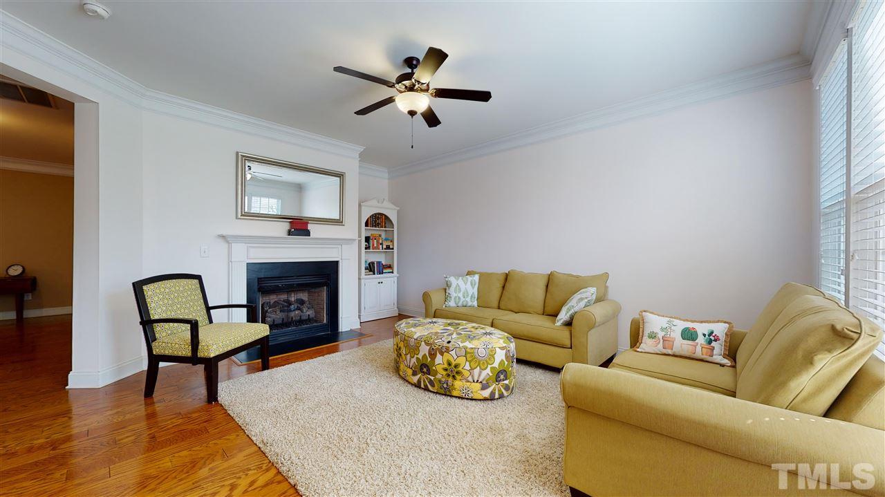 628 Democracy Street Raleigh, NC 27603 - Photo 4 of 26 a living room with furniture and a fireplace