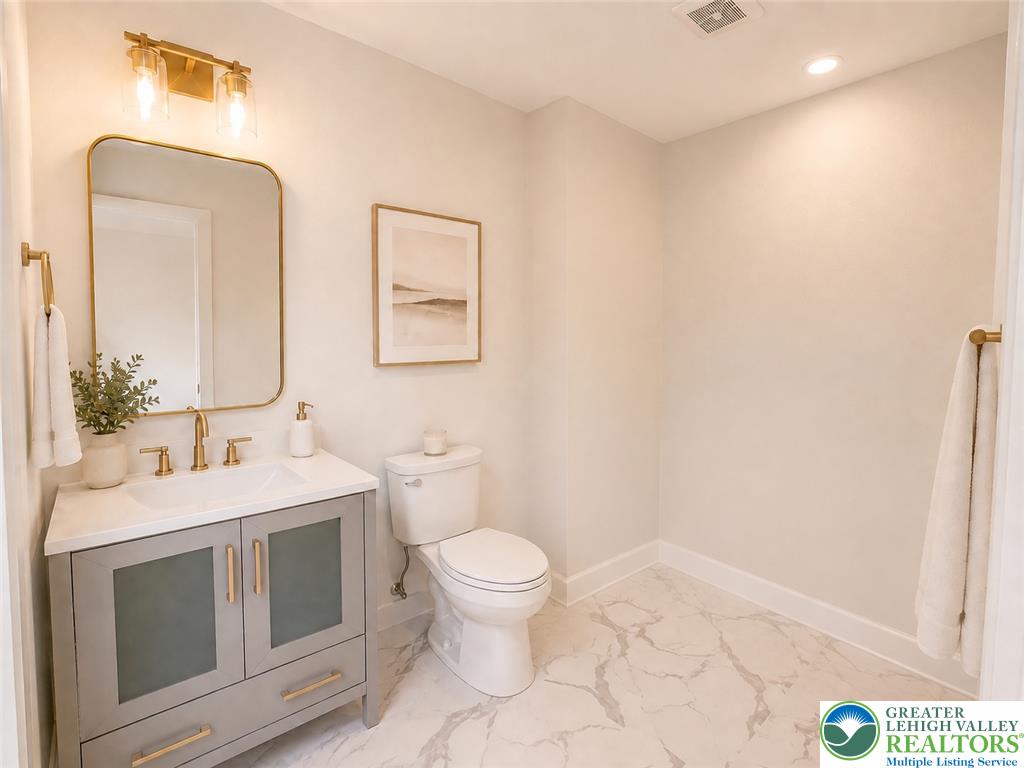3104 Moyer Road Hellertown, PA 18055 - Photo 19 of 24 Elegant marble-patterned tile flooring anchors this modern washroom featuring a sleek single vanity setup.