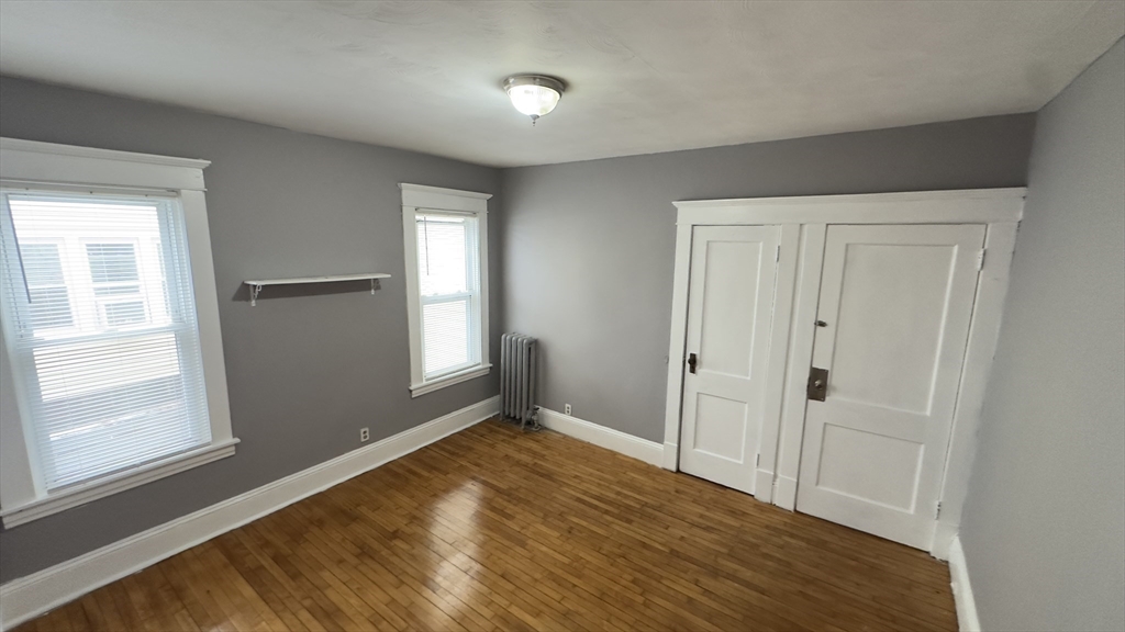 42-44 Narragansett Street, Unit 1 Springfield, MA 01107 - Photo 8 of 10 a view of empty room with wooden floor and fan
