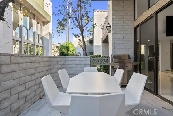 a view of a patio with table and chairs