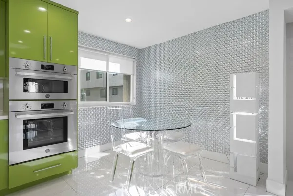 a kitchen with stainless steel appliances kitchen island granite countertop a stove a sink and a microwave