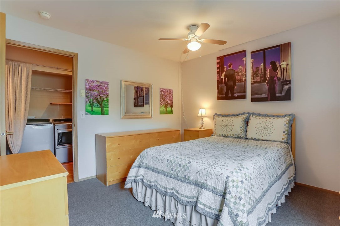 15150 140th Way Southeast, Unit N102 Renton, WA 98058 - Photo 12 of 20 a bedroom with a bed and a chandelier