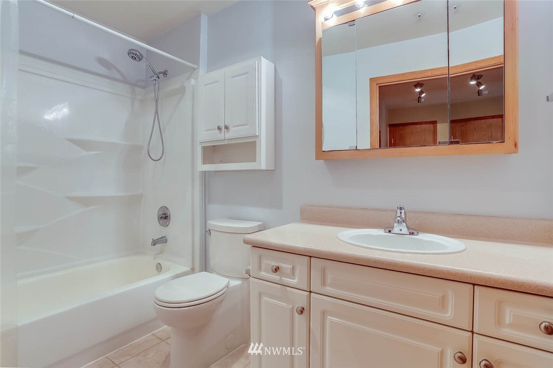 15150 140th Way Southeast, Unit N102 Renton, WA 98058 - Photo 13 of 20 a bathroom with a sink a toilet and shower