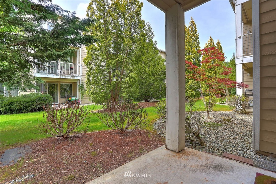 15150 140th Way Southeast, Unit N102 Renton, WA 98058 - Photo 15 of 20 a front view of a house with garden