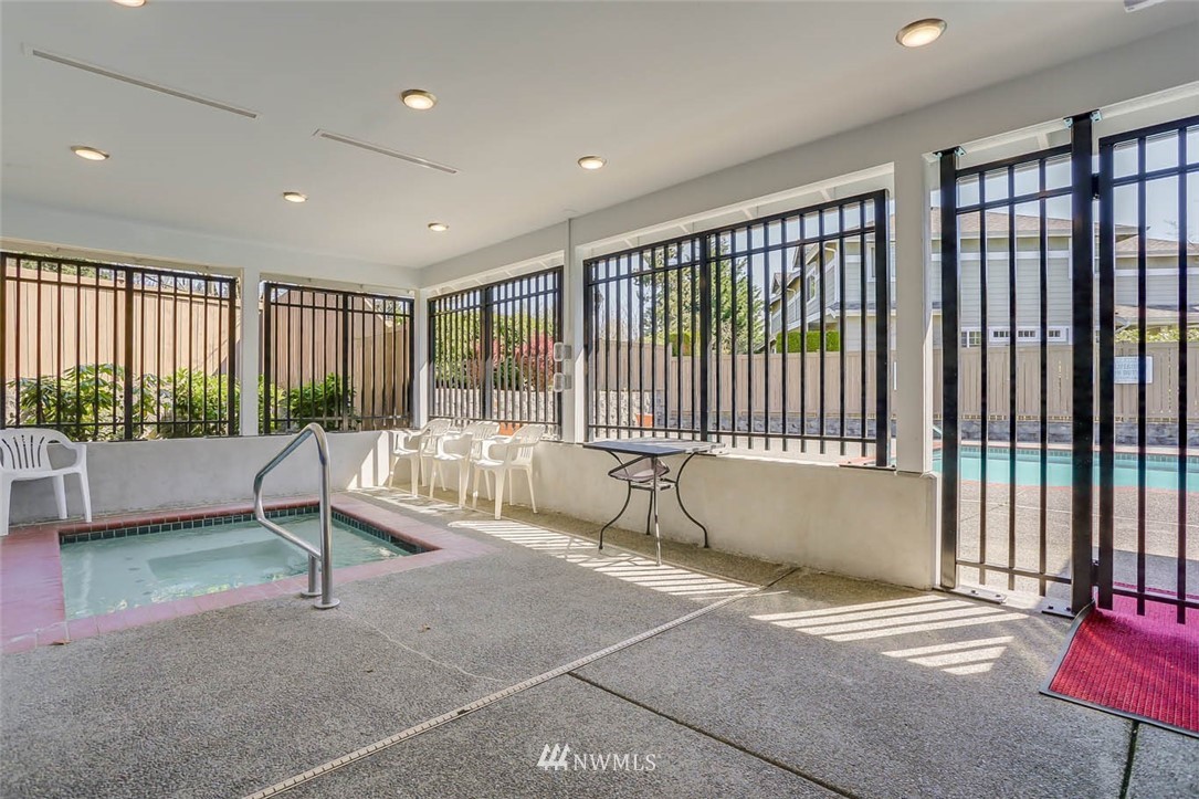 15150 140th Way Southeast, Unit N102 Renton, WA 98058 - Photo 17 of 20 a living room filled with furniture and a floor to ceiling window