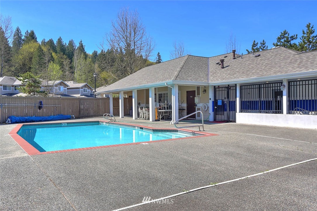 15150 140th Way Southeast, Unit N102 Renton, WA 98058 - Photo 18 of 20 a view of a house with pool and chairs