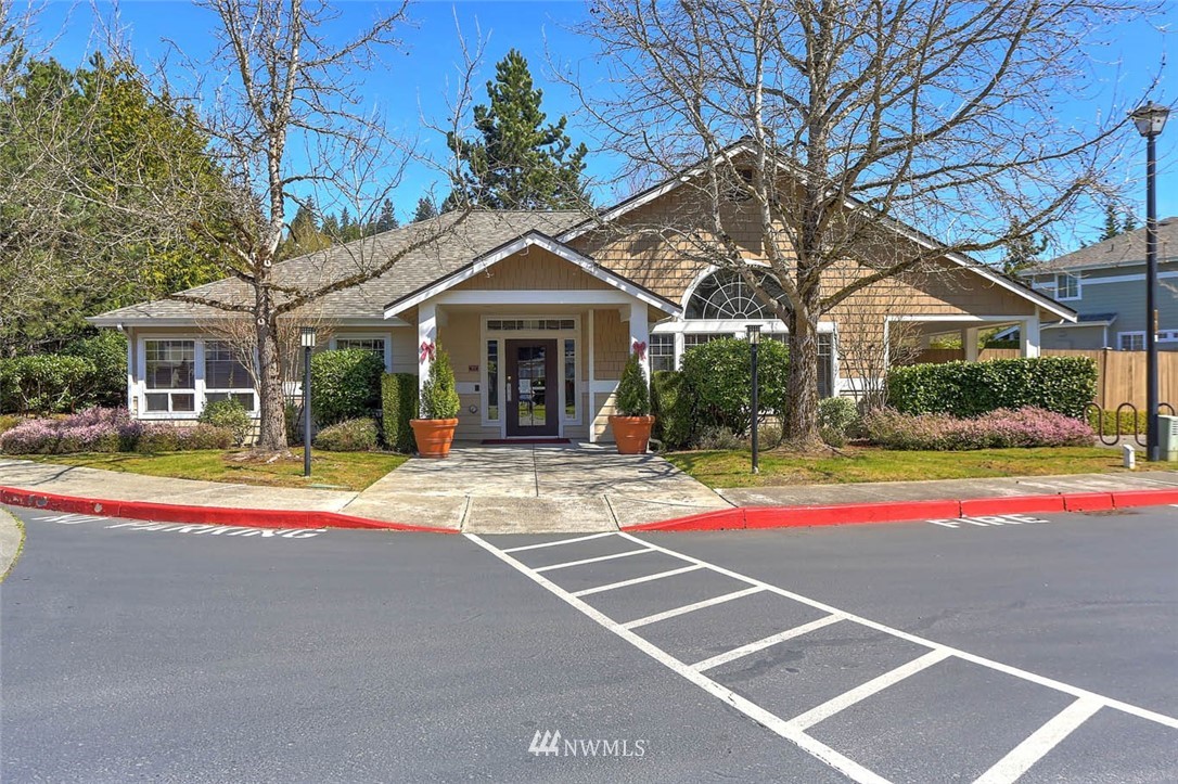 15150 140th Way Southeast, Unit N102 Renton, WA 98058 - Photo 19 of 20 a view of a white house with a large windows next to a road