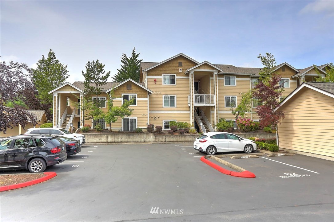 15150 140th Way Southeast, Unit N102 Renton, WA 98058 - Photo 20 of 20 a car parked in front of a house