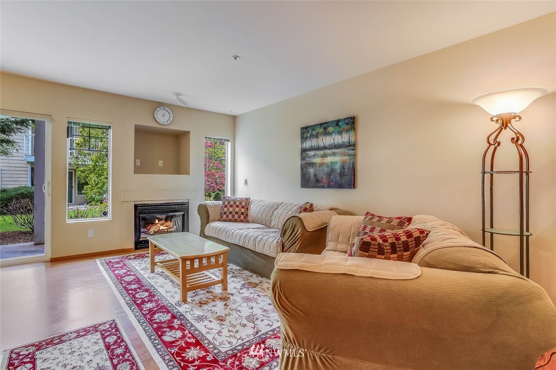 15150 140th Way Southeast, Unit N102 Renton, WA 98058 - Photo 3 of 20 a bedroom with furniture and a fireplace