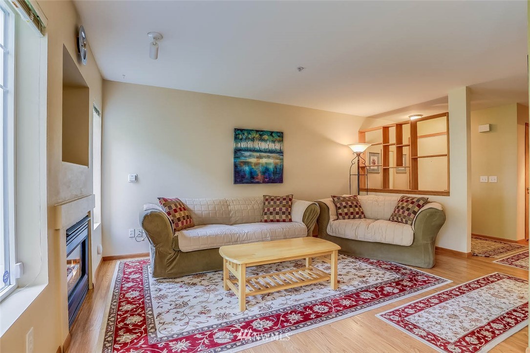 15150 140th Way Southeast, Unit N102 Renton, WA 98058 - Photo 4 of 20 a living room with furniture and a rug
