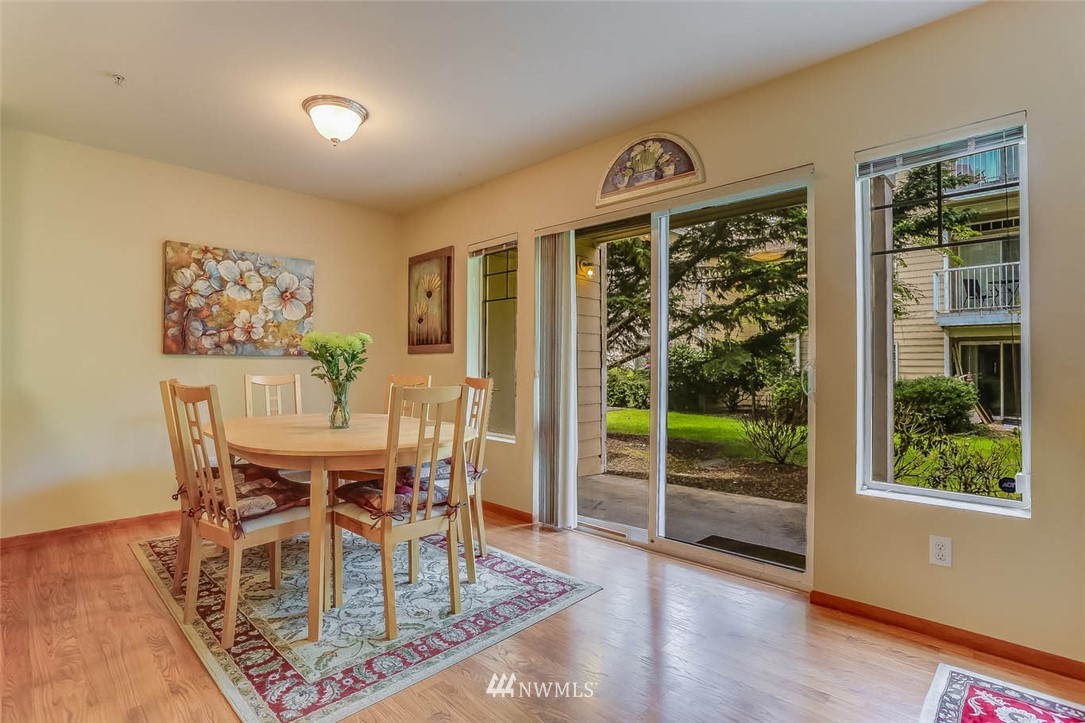 15150 140th Way Southeast, Unit N102 Renton, WA 98058 - Photo 6 of 20 a view of a dining room with furniture window and wooden floor