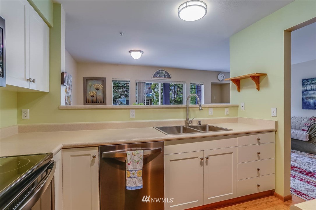 15150 140th Way Southeast, Unit N102 Renton, WA 98058 - Photo 8 of 20 a kitchen with a sink and cabinets