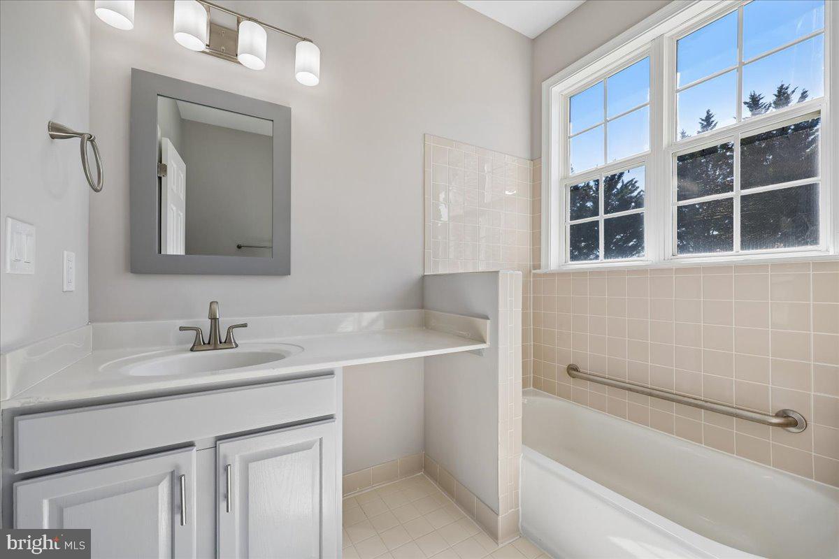 21712 Slidell Road Boyds, MD 20841 - Photo 16 of 32 a bathroom with a sink and a mirror