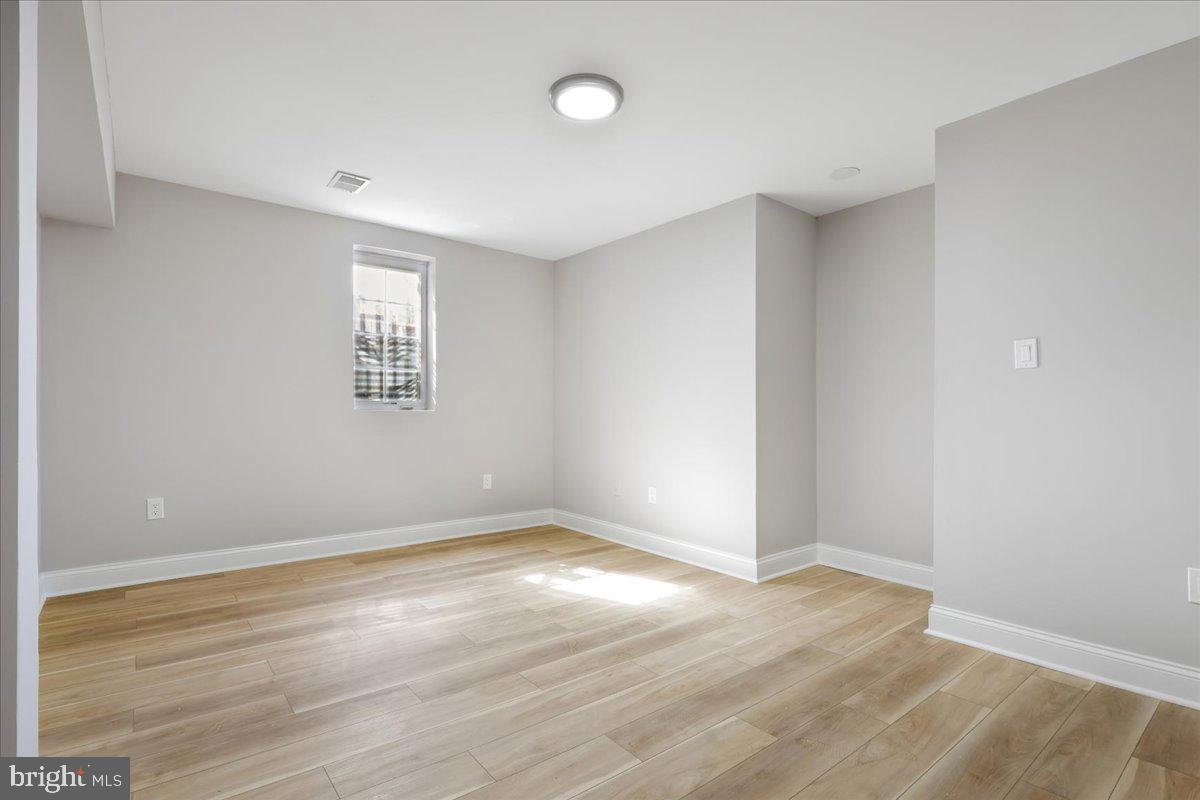 21712 Slidell Road Boyds, MD 20841 - Photo 20 of 32 wooden floor in an empty room with a window