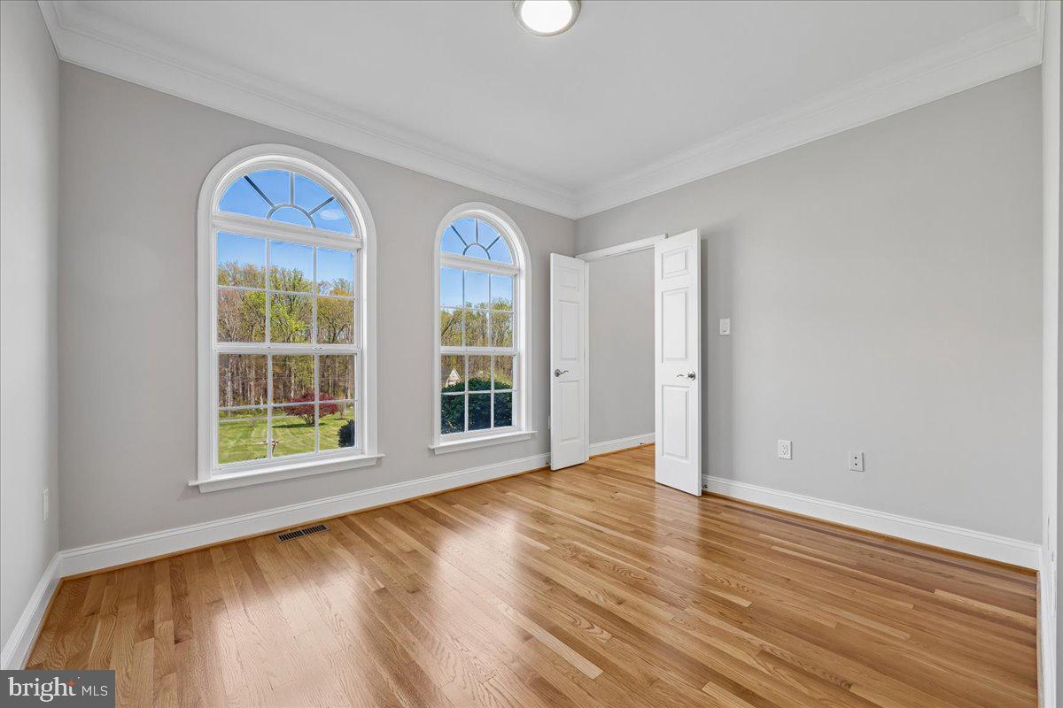 21712 Slidell Road Boyds, MD 20841 - Photo 6 of 32 a view of an empty room with wooden floor and a window
