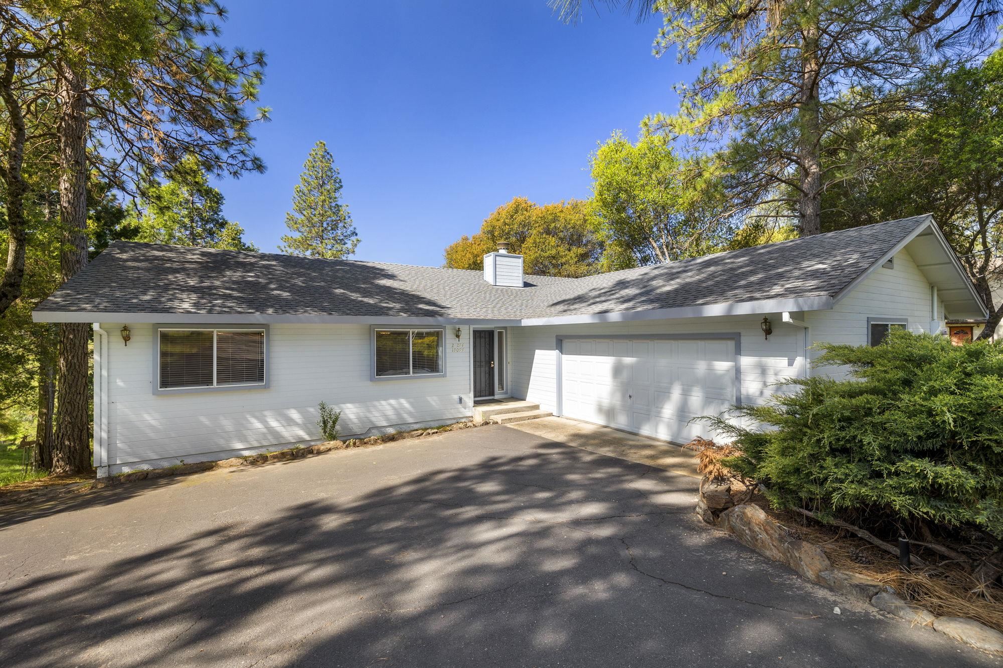 19099 Raboul Court Groveland, CA 95321 - Photo 1 of 58 a front view of a house with a yard and potted plants