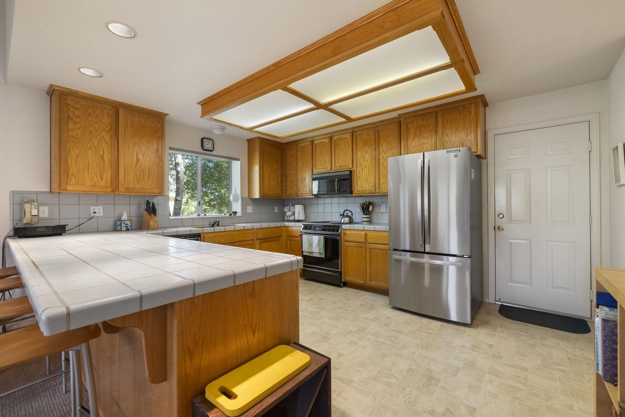 19099 Raboul Court Groveland, CA 95321 - Photo 12 of 58 a kitchen with refrigerator and window