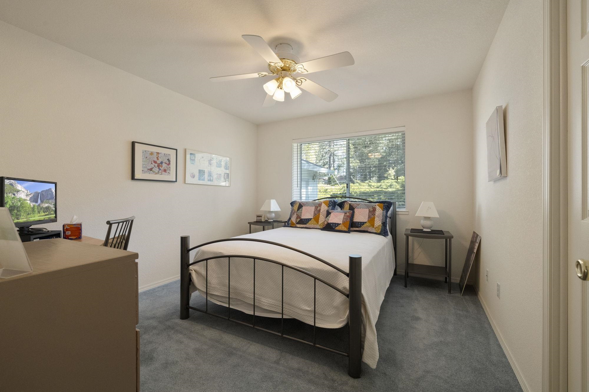 19099 Raboul Court Groveland, CA 95321 - Photo 16 of 58 a bed room with a bed and a chandelier