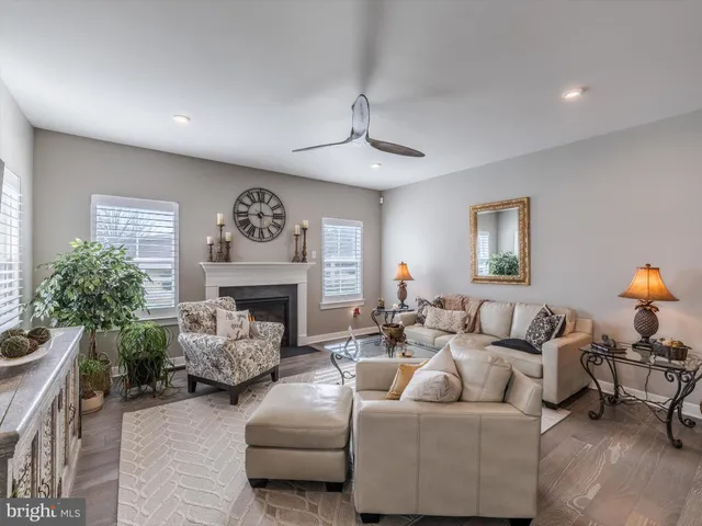 a living room with furniture a fireplace and a chandelier