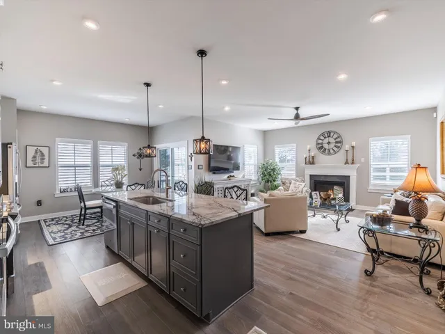 a living room with furniture a fireplace and a chandelier