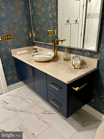 a bathroom with a sink vanity and a mirror