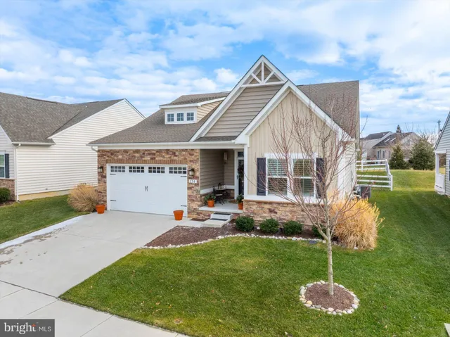 a front view of house with a garden and patio
