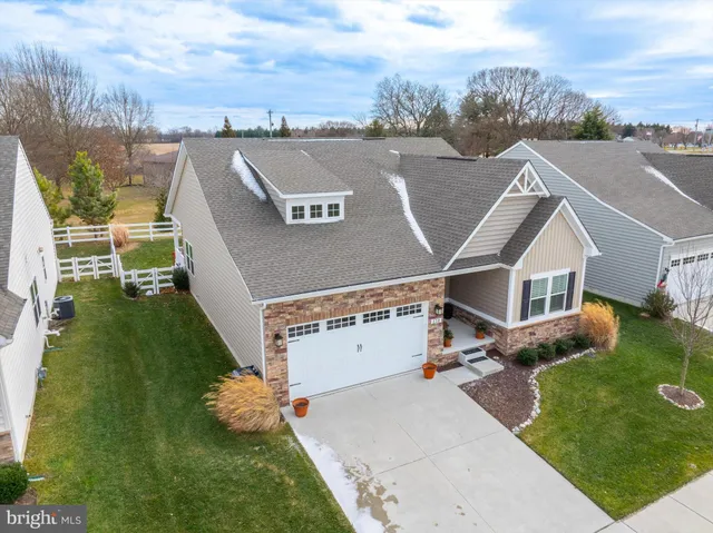 an aerial view of residential houses with outdoor space and parking