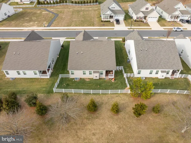 an aerial view of residential houses with outdoor space and parking