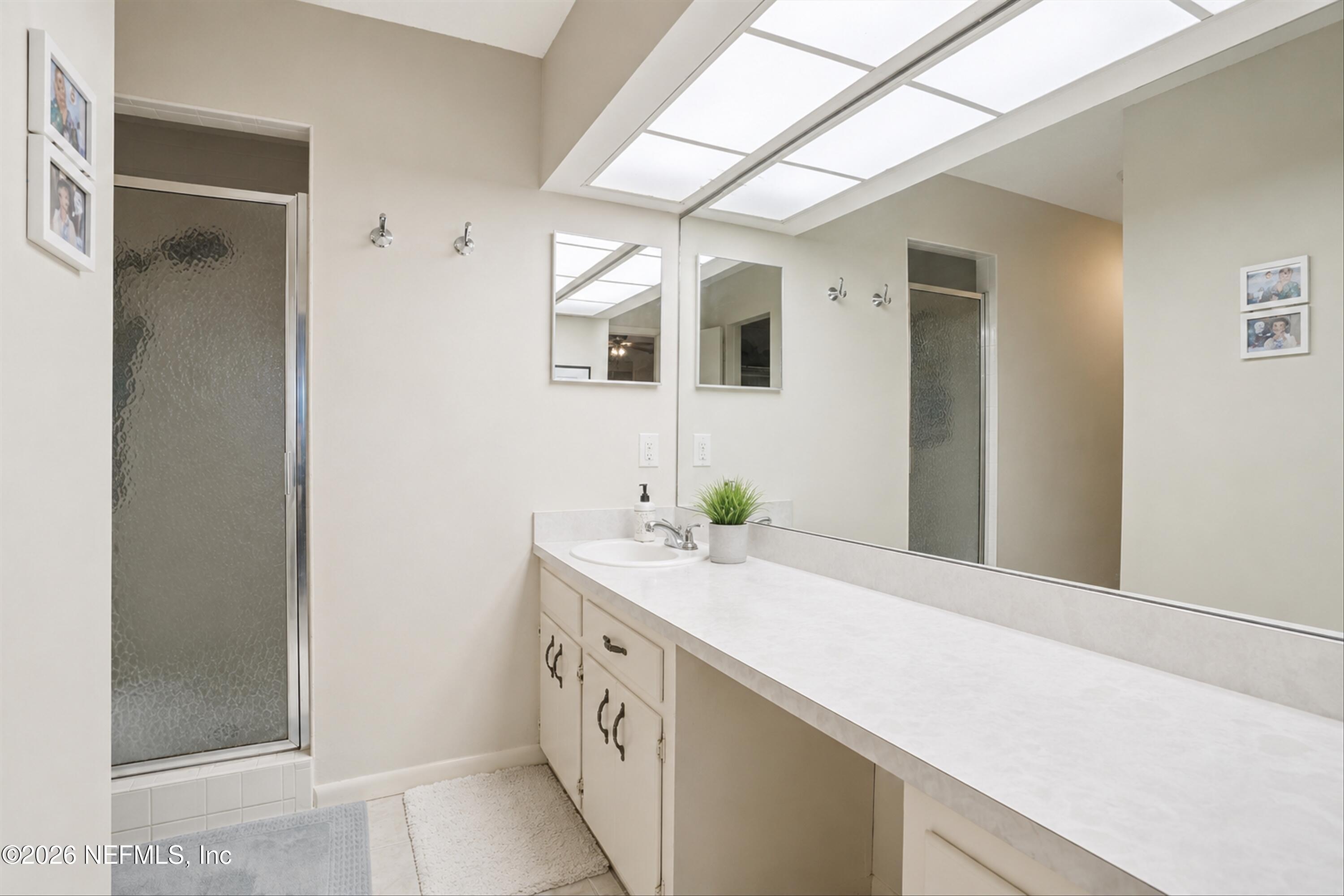 124 Hopkins Street Neptune Beach, FL 32266 - Photo 12 of 44 a bathroom with a sink and a mirror