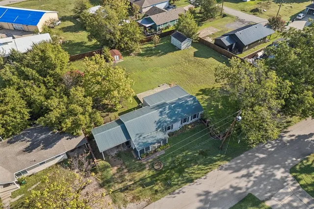 an aerial view of a house with a yard