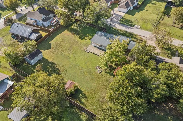 an aerial view of residential house with swimming pool and lawn chairs