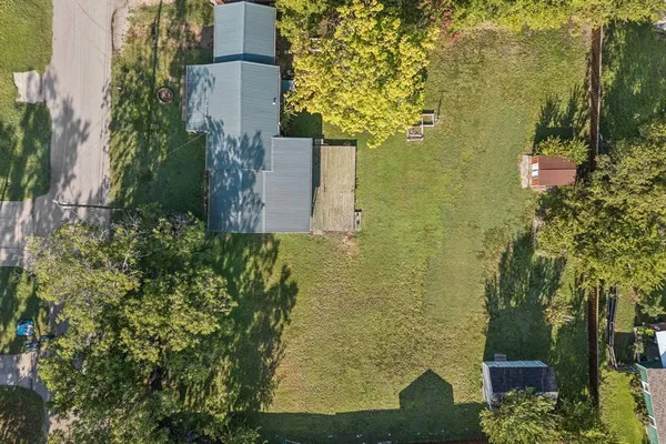 an aerial view of a houses with yard