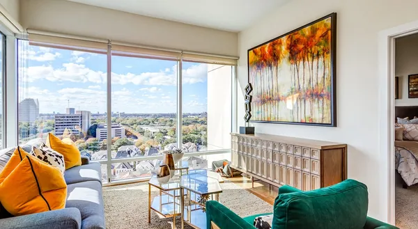 a living room filled with furniture and a large window