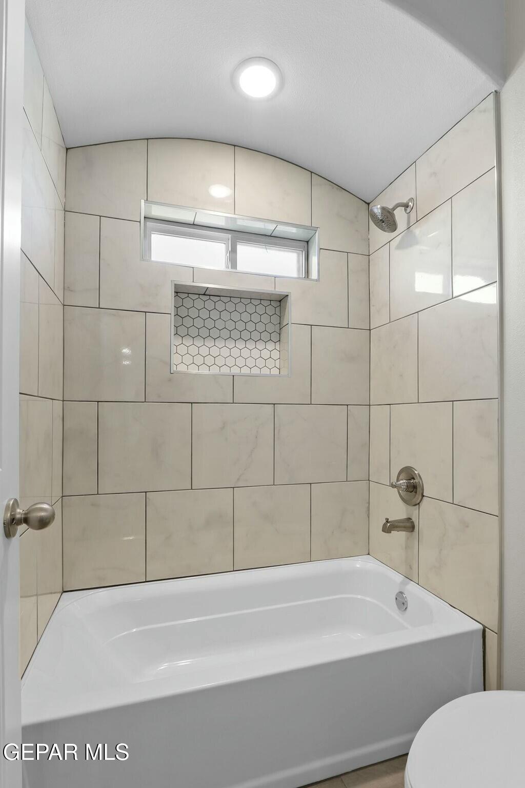 3872 Object Place El Paso, TX 79938 - Photo 26 of 33 a bathroom with a bathtub and a shower