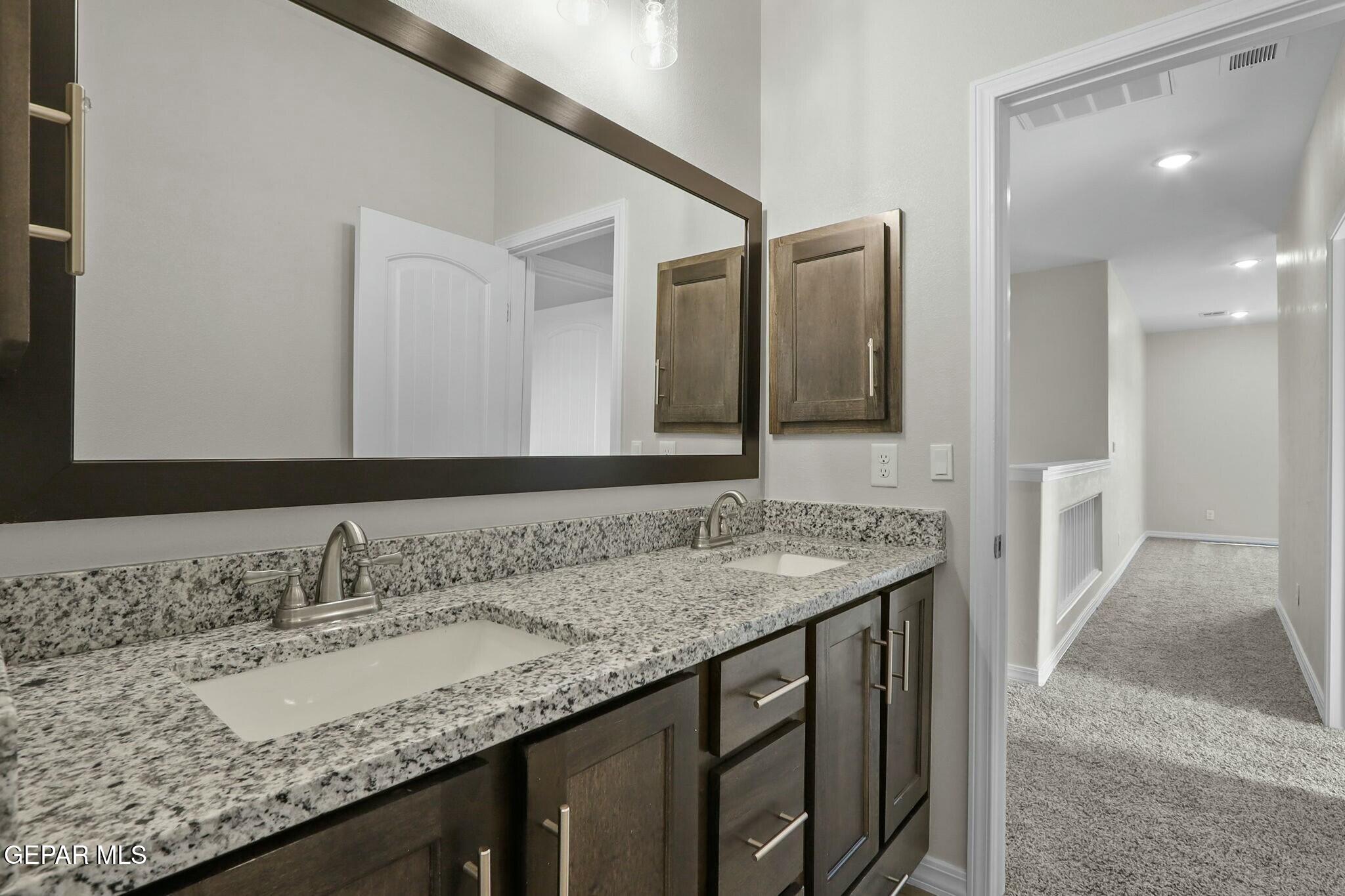 3872 Object Place El Paso, TX 79938 - Photo 27 of 33 a bathroom with a granite countertop sink and a mirror